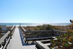 a boardwalk to the beach with the ocean in the background at Dry Dock 101 in Myrtle Beach