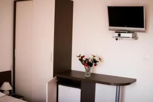 a room with a table with a vase of flowers on it at B&B Sidro in Vodice