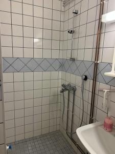 a bathroom with a shower and a sink at Bed & Padel in Aavasaksa