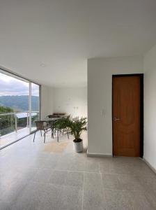 a room with a wooden door and a table and chairs at Hotel Dorado San Luis in San Luis