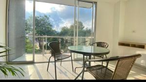 a dining room with a glass table and chairs at Hotel Dorado San Luis in San Luis