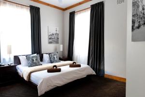 Ένα ή περισσότερα κρεβάτια σε δωμάτιο στο Ashanti Gardens Guesthouse