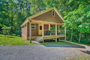 a small cabin in the middle of a forest at Peaceful Decatur Cabin with Grill and Fire Pit! in Decatur
