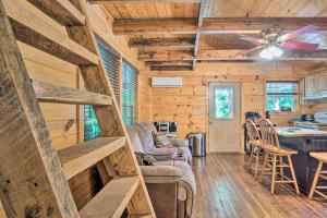 a log cabin with a kitchen and a living room at Peaceful Decatur Cabin with Grill and Fire Pit! in Decatur