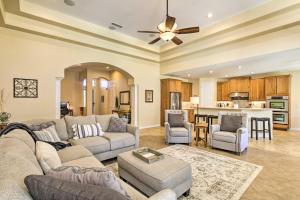 a living room with a couch and a table at Laveen Village Getaway with Pool, 11 Mi to Phoenix! in Phoenix