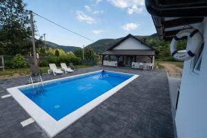 a swimming pool in a yard with a gazebo at Vikendica Lohovo in Bihać