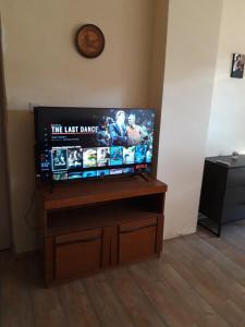 a flat screen tv sitting on top of a wooden stand at Apartman Adriatic BnM in Biograd na Moru