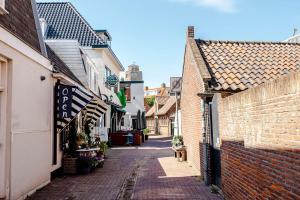 an alley in a small town with buildings at Bluys Apartment in Zandvoort