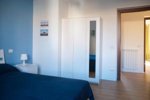 a bedroom with a blue bed and a mirror at Welcome Friends in Rome