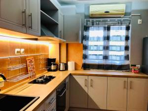 a kitchen with white cabinets and a stove top oven at Joy City Stay Victoriei 7G-3 in Timişoara