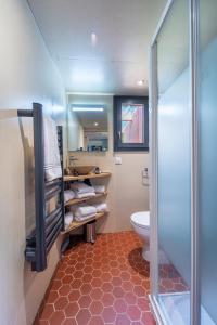 a bathroom with a toilet and a glass shower at Les Lodges du Morvan in Brazey-en-Morvan