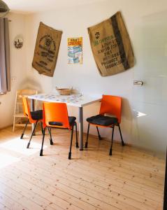 a dining room with a table and two chairs at Erholung am Vulkanradweg - 4 Sterne DTV Zertifiziert in Bad Salzschlirf