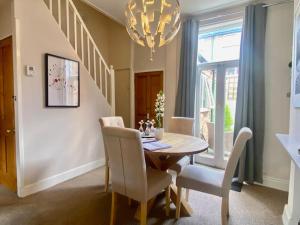 a dining room with a table and chairs and a chandelier at Comfy Home within City Wall, 10 mins Walk to Centre, Attractions & Railway Station in York