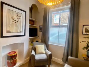 a living room with a chair and a window at Comfy Home within City Wall, 10 mins Walk to Centre, Attractions & Railway Station in York