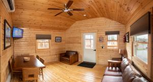 a living room with a ceiling fan and a table at Cherry Hill Park in College Park