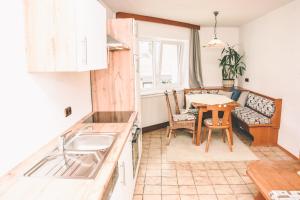 a kitchen and dining room with a table and chairs at Pension s'Platzl Stuhleck in Spital am Semmering