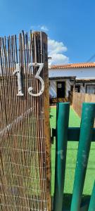 a fence with a sign on it next to a house at Sunrise Monsaraz Green - 1km Castelo Monsaraz com telheiro e jardim in Monsaraz