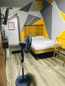 A bed or beds in a room at Alina Budget Hotel