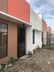 a side view of a house with a black door at P&Y 114 House for rent in Bayugan City