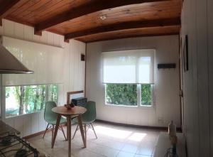 a kitchen with a table and chairs and a window at Casa Roja in El Calafate