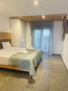 Postel nebo postele na pokoji v ubytování Asteras Hotel