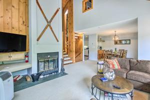 a living room with a couch and a fireplace at Cozy Lincoln Condo about 1 Mi to Loon Mountain! in Lincoln