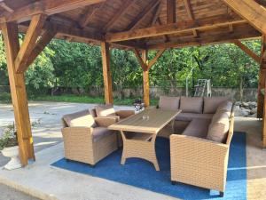 a patio with a couch and a table and chairs at Šimun in Karlovac