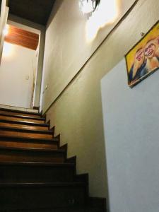 a staircase in a building with a painting on the wall at Casa Bambú Tropical in Alajuela