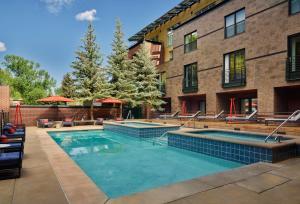 a swimming pool in front of a building at Limelight Hotel Aspen in Aspen