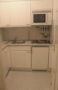 a small kitchen with a sink and a microwave at Iderhoff Iderhoff 08 in Norderney