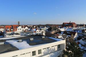 a city with snow on the roofs of buildings at Iderhoff Iderhoff 08 in Norderney
