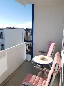 a balcony with a table and chairs on a balcony at Iderhoff Iderhoff 19 in Norderney