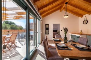 a kitchen and dining room with a table and chairs at HACIENDA GASPAROVIC in Sukošan