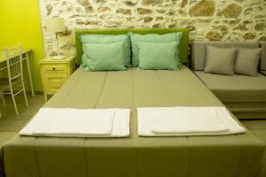 a large bed with two pillows on top of it at AFISSOS SEASIDE STUDIOS in Afissos