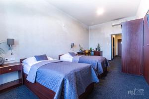Posteľ alebo postele v izbe v ubytovaní Hotel Centrum