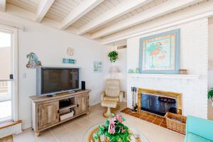 a living room with a television and a fireplace at Wight Street - Unit 2 in Ocean City