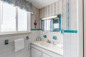 a bathroom with a sink and a mirror at Wight Street - Unit 2 in Ocean City +16 photos