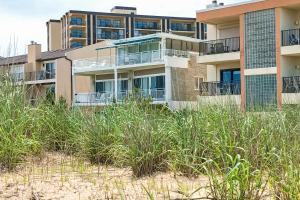 an apartment building on the beach with tall grass at Wight Street - Unit 2 in Ocean City
