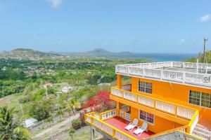 an orange building with two chairs on top of it at Belle View Apartment Villas in Laborie