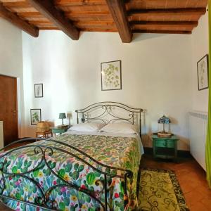 a bedroom with a bed in a room with wooden ceilings at B&B Il Fienile San Gimignano in San Gimignano