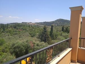 a balcony with a view of a forest at Ligeris house 1 in Agioi Deka in Áyioi Dhéka