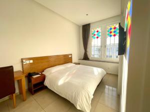 מיטה או מיטות בחדר ב-Hotel Lutece
