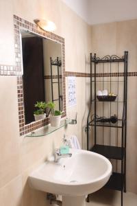 a bathroom with a sink and a mirror at MaGia Peristeridi in Polychrono