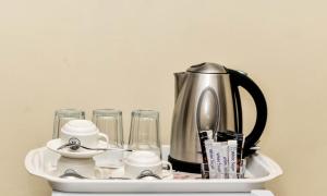 a tray with a tea kettle and glasses on it at Forodhani Park Hotel in Zanzibar City
