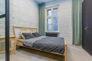 a bedroom with a bed and a brick wall at Krásny byt v historickom centre Bratislavy in Bratislava