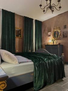 a bedroom with a bed with a green blanket on it at Luxus Design Apartments in Plauen