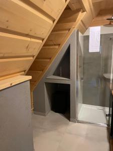an attic room with a refrigerator in the middle at APARTAMENT GLICZARÓWKA in Gliczarów