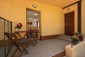 a balcony with a table and chairs and a door at Apartmán pod čerešňou in Banská Štiavnica +5 photos