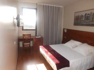 Postel nebo postele na pokoji v ubytování Hotel Reus Park