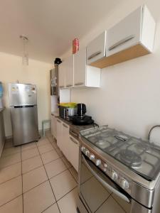a kitchen with a stove and a refrigerator at Atacama Valley 10 in Copiapó